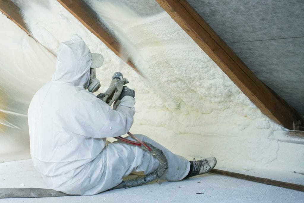 man spraying spray foam insulation for maximum r value