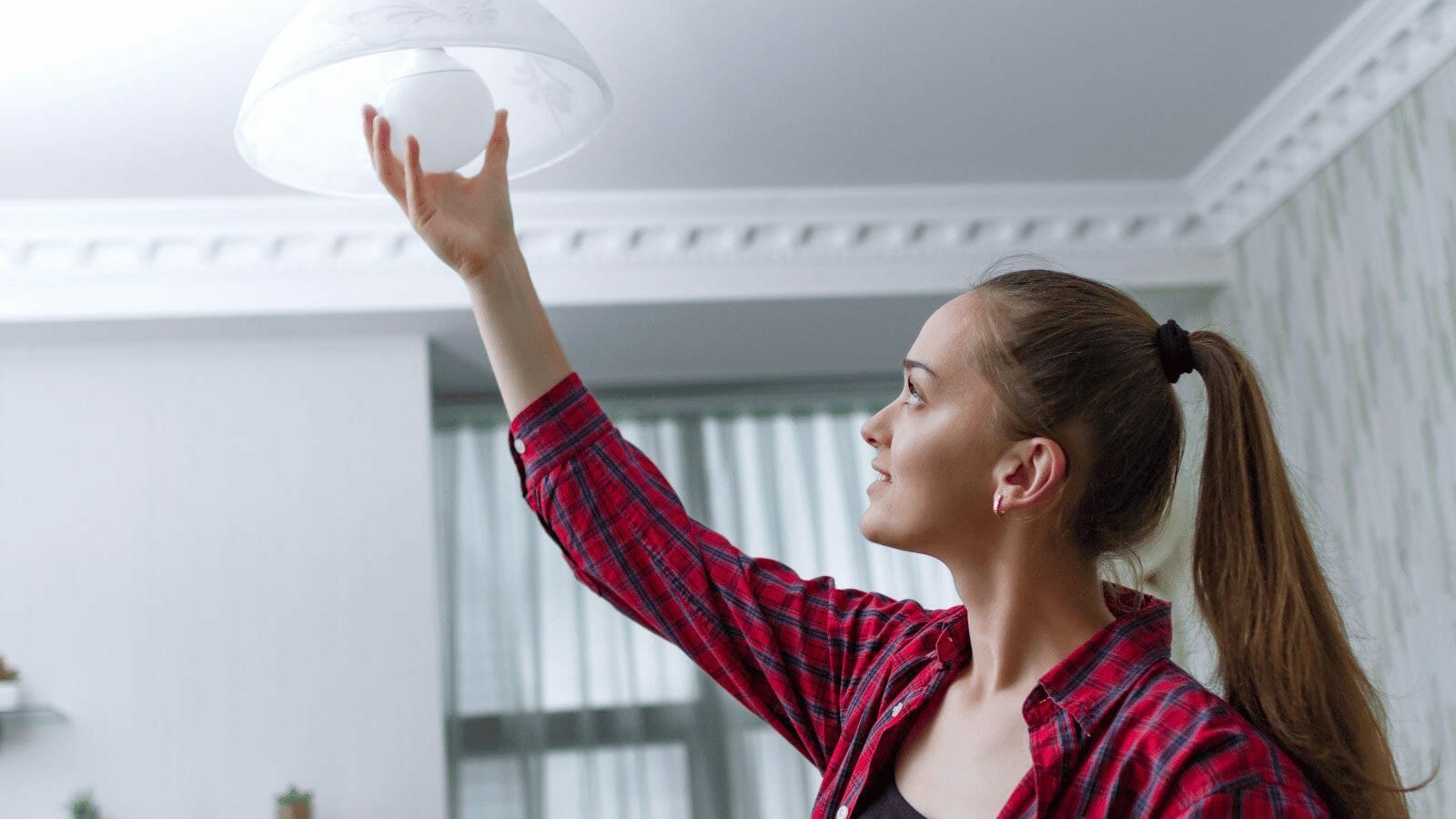 woman changing lightbulb