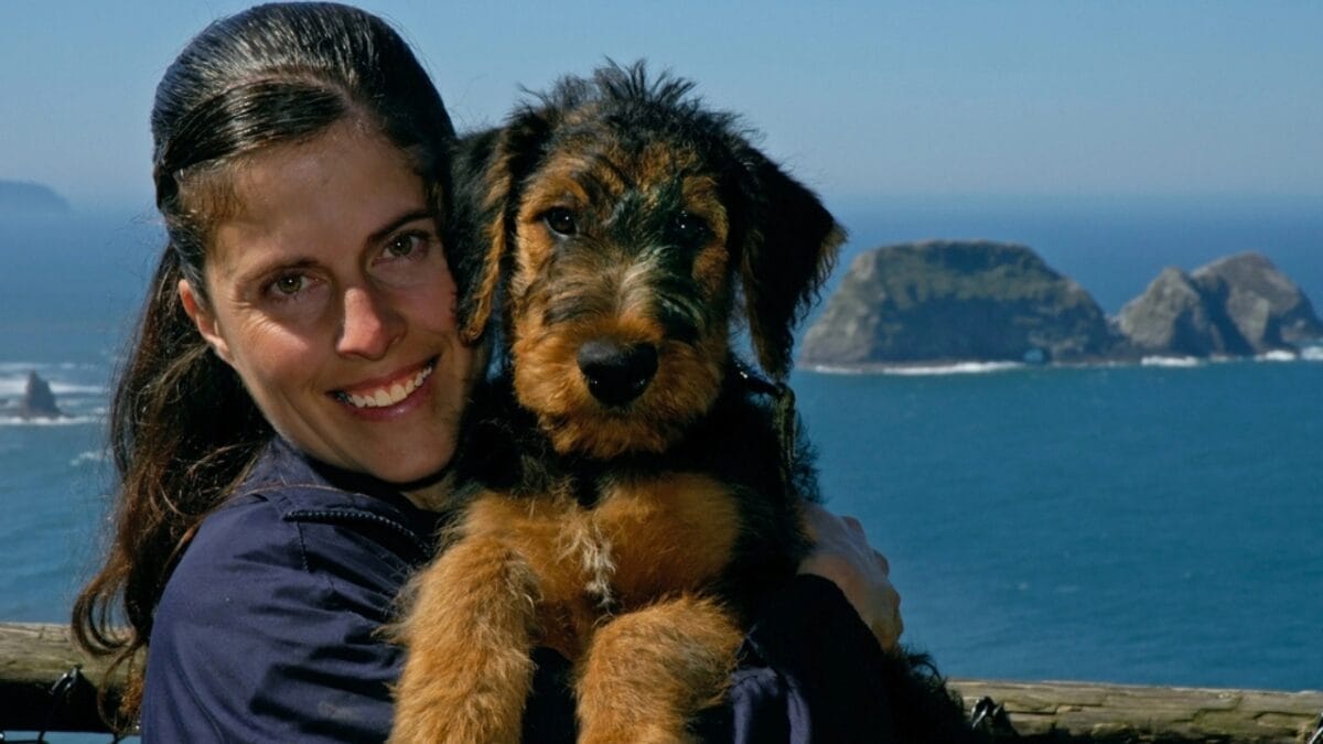 10 Reasons Why Older Dogs Make the Best Pets - woman holding airedale terrier dog dp2035871